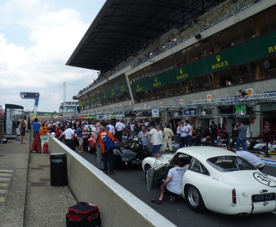 The Le Mans Legend field congregate in the pitlane ahead of the start of the support race
