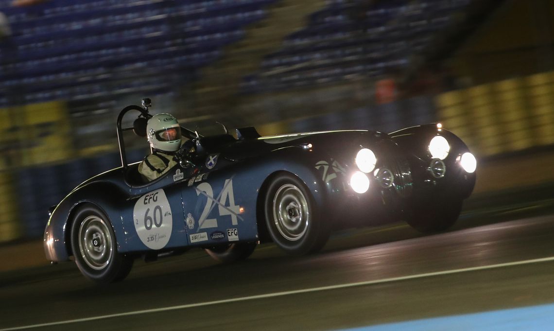 The Ecurie Ecosse Jaguar XK120 contends the challenging circuit during one of the night races