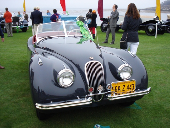 The recently restored XK120 on display on the 18th fairway of the Pebble Beach golfcourse